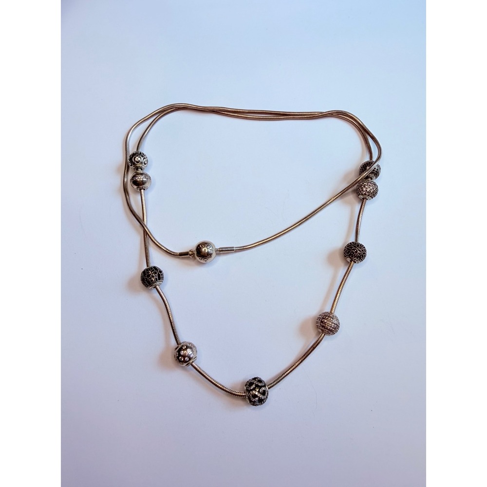 Pandora sterling silver snake chain necklace with multiple Pandora charms.